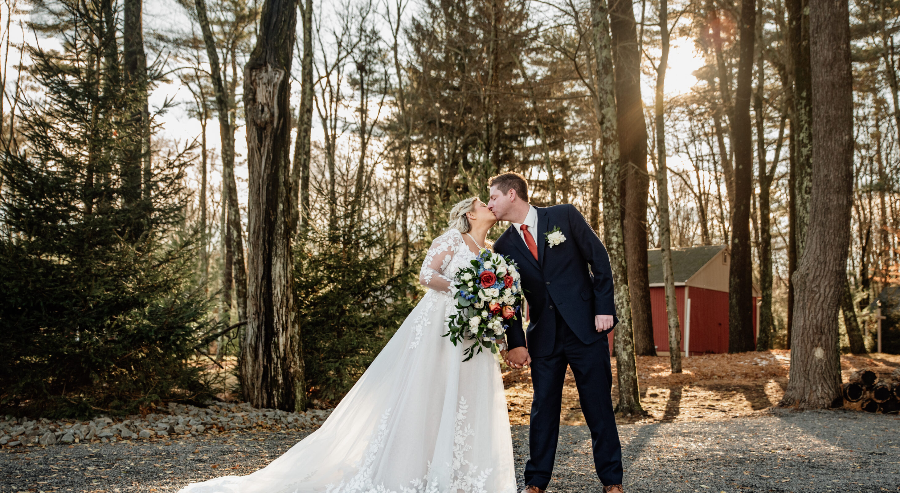 Couple walking through trees at Poconos mountain wedding venue