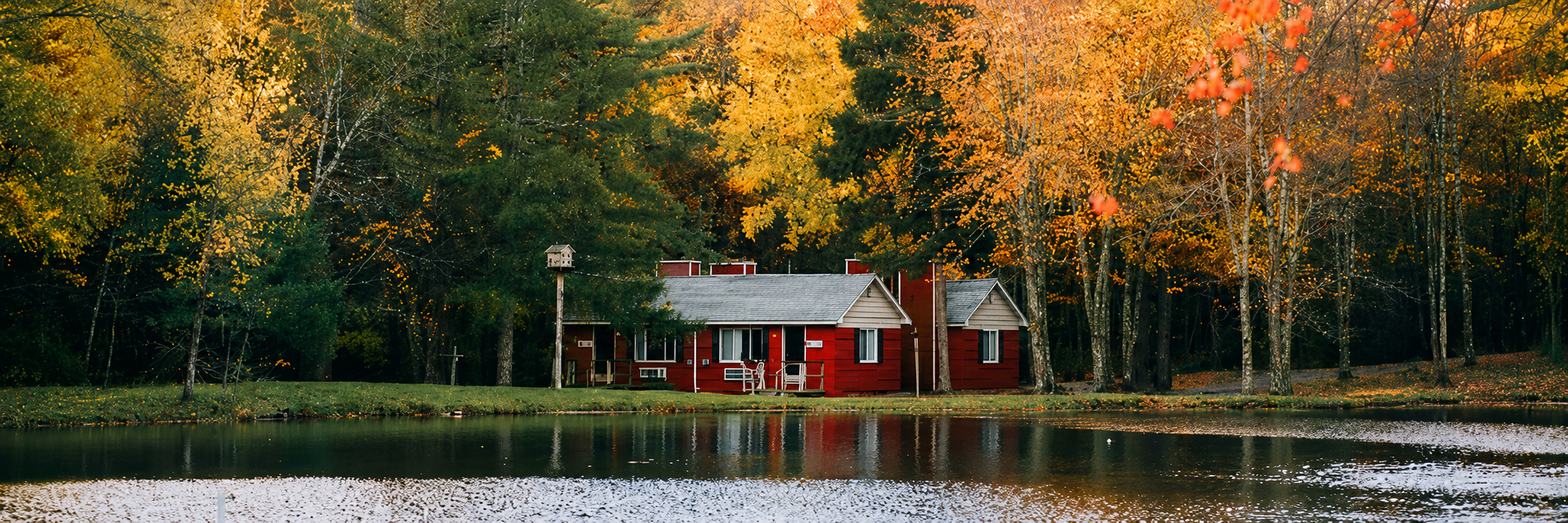 Red cottages on the lake offering Mt. Pocono lodging