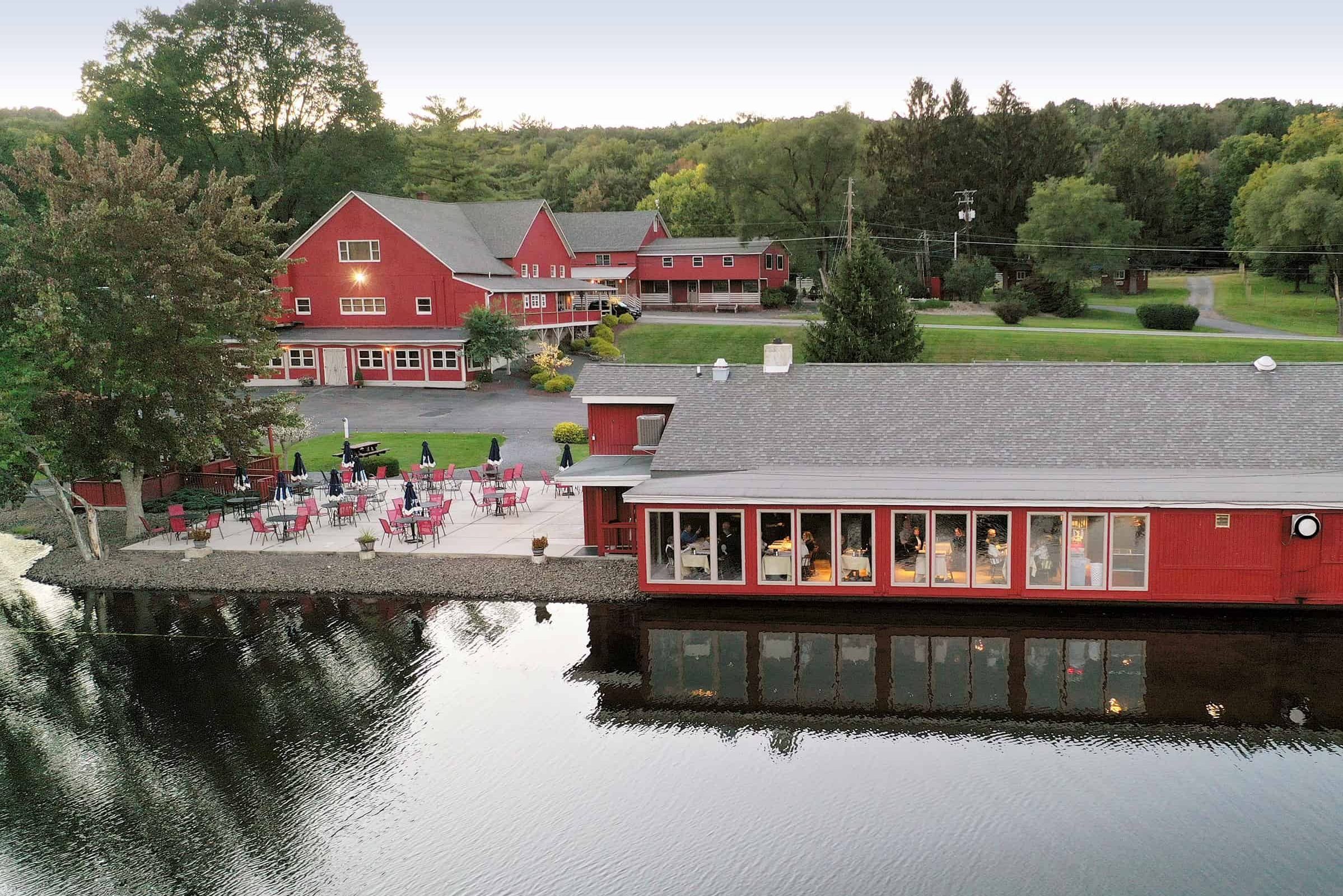 Property view of red building on a lake at Mt. Pocono resort
