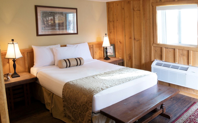 Wood walled cabin room at Grange Valley inn