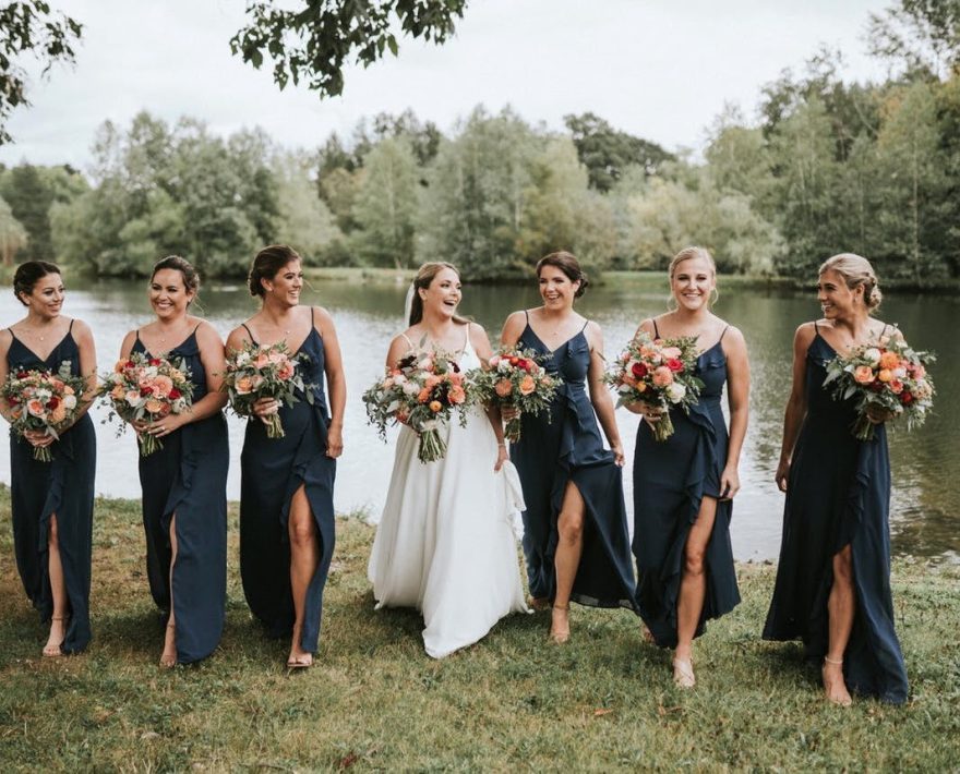 Bride and bridesmaids by lake at Poconos wedding venue