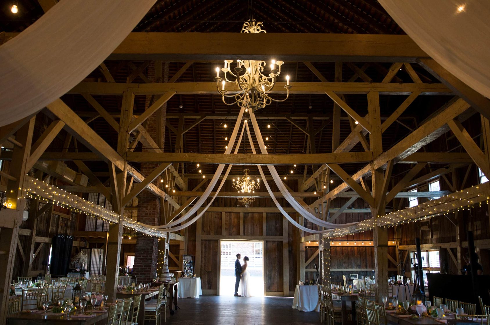 Couple in event barn at lakefront wedding venue in Mount Pocono, PA