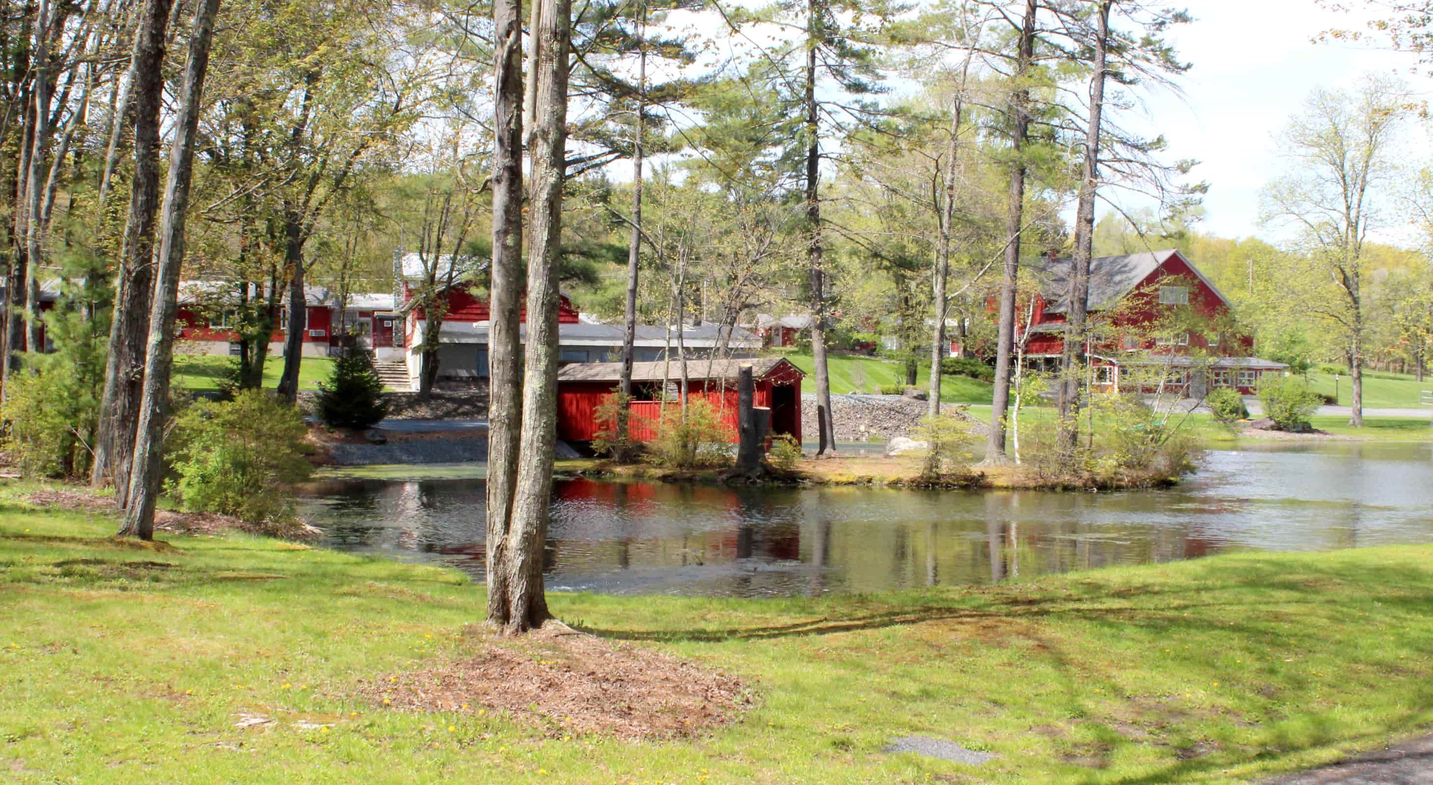 Property view of red building on a lake at Mt. Pocono resort