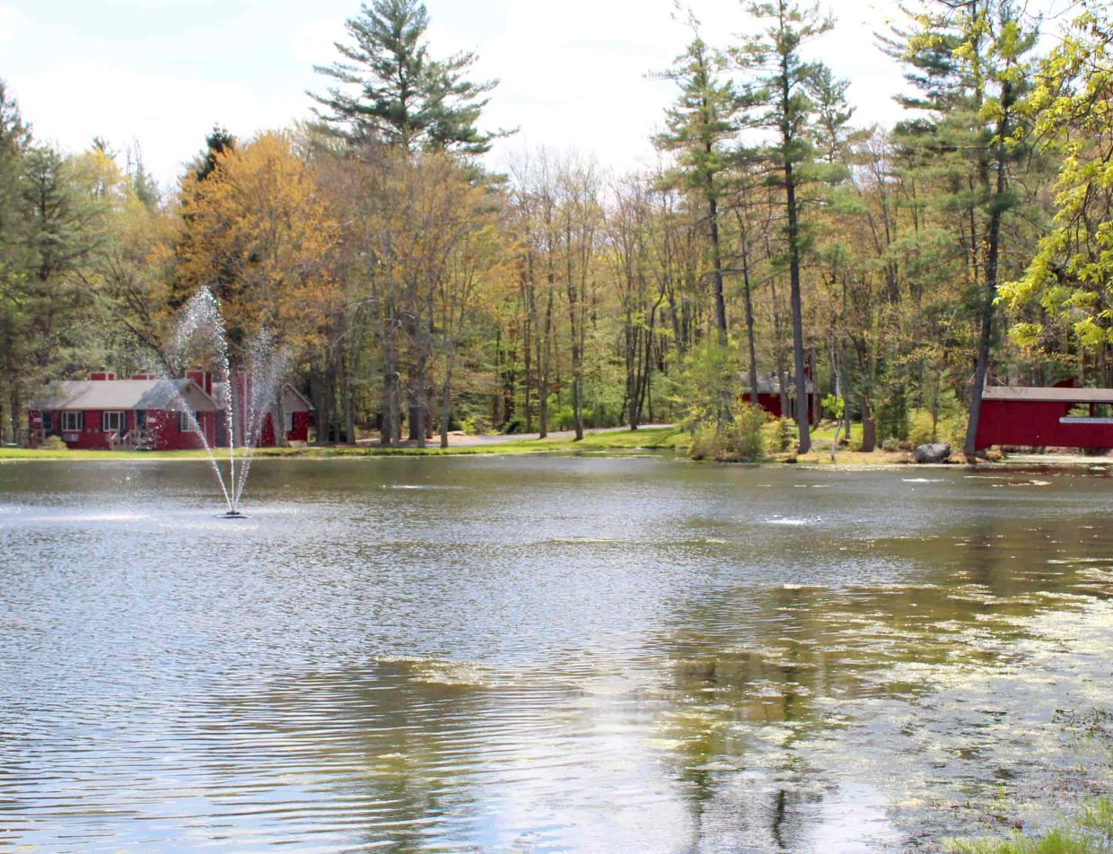 Lake view of red cottages at Mount Pocono, PA inn
