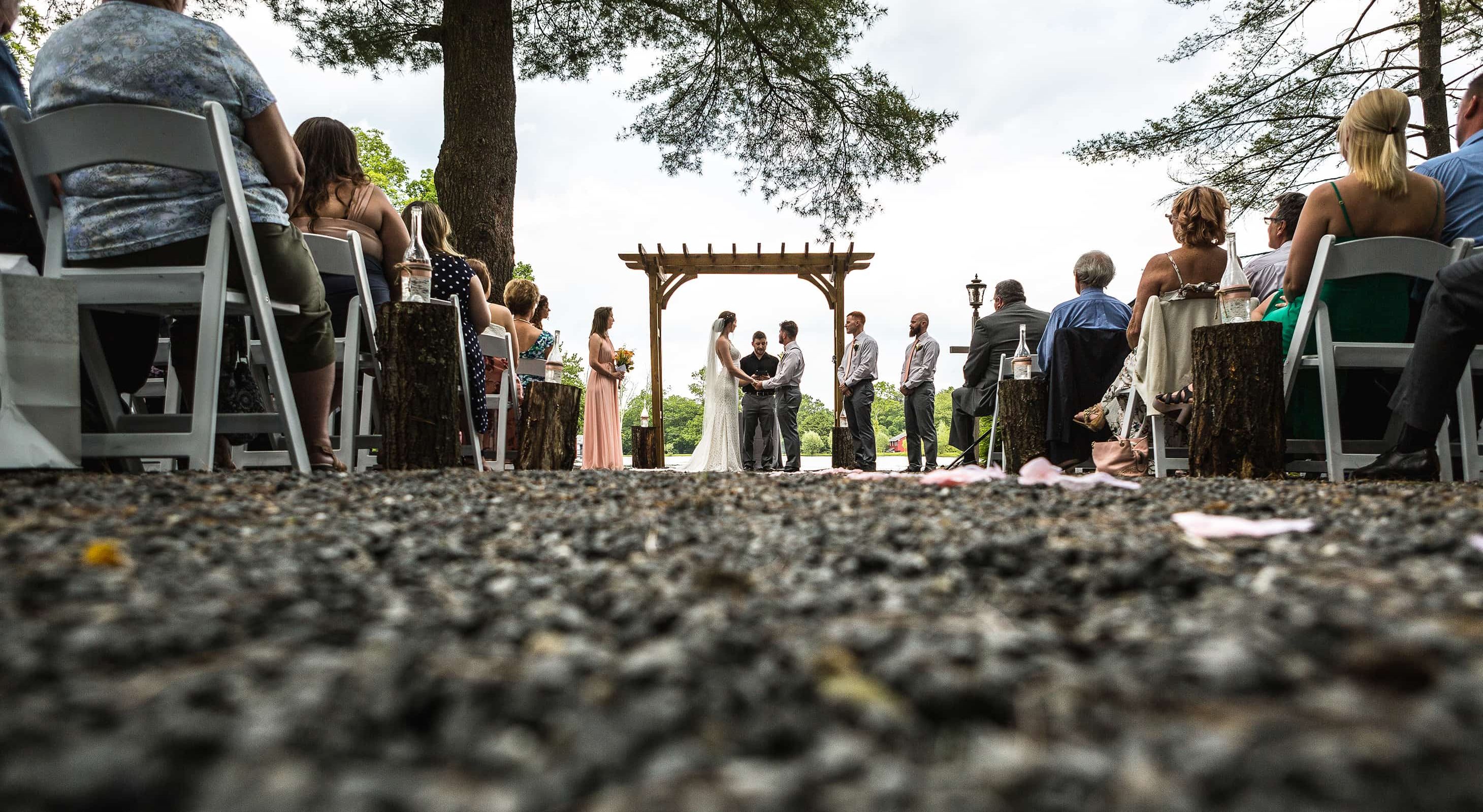 Couple getting married by a lake in the Poconos mountains
