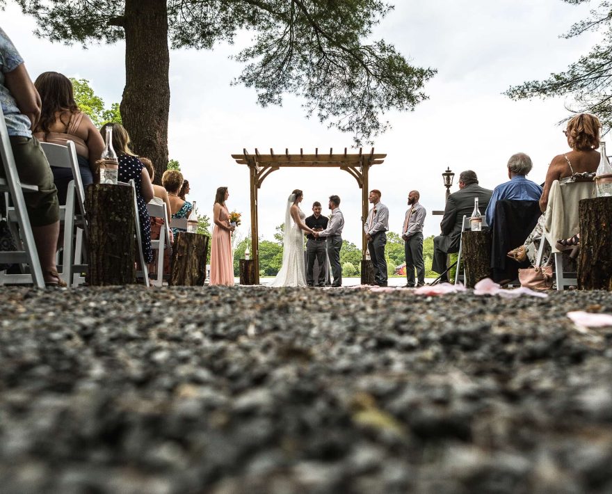 Couple getting married by a lake in the Poconos mountains
