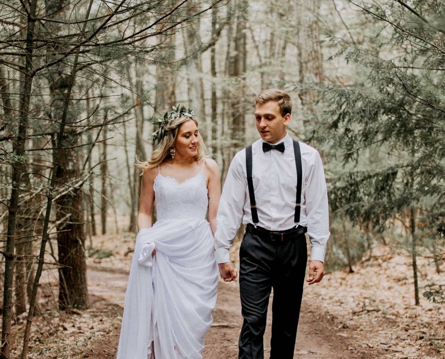 Couple walking through trees at Mount Pocono, PA wedding venue