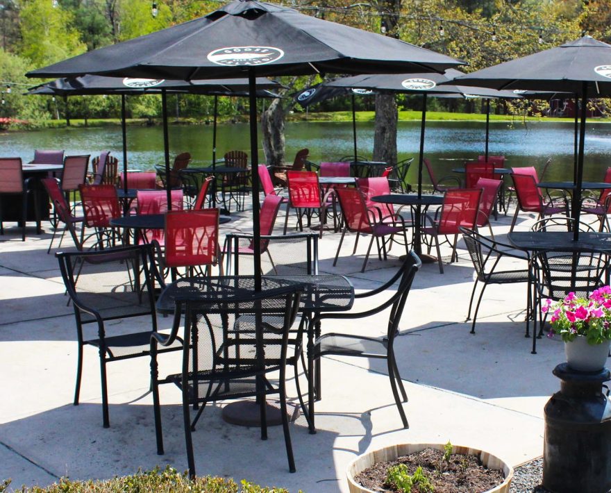 Patio dining with water views at Grange Valley restaurant The Water's Edge