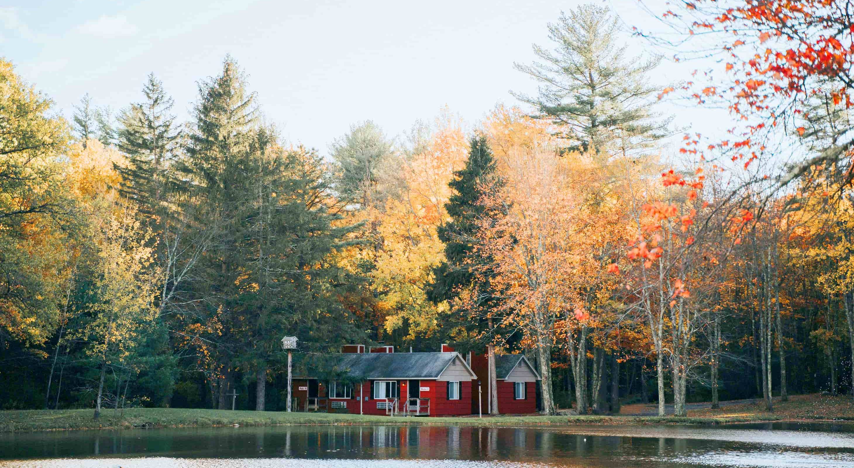 Red cottages on the lake offering Mt. Pocono lodging