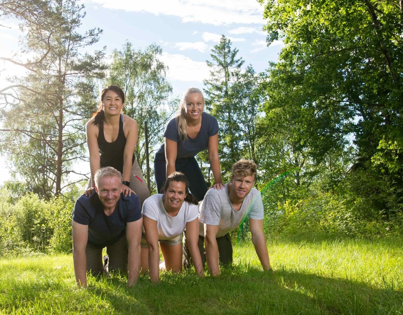 Corporate team members building pyramid at Poconos retreat venue