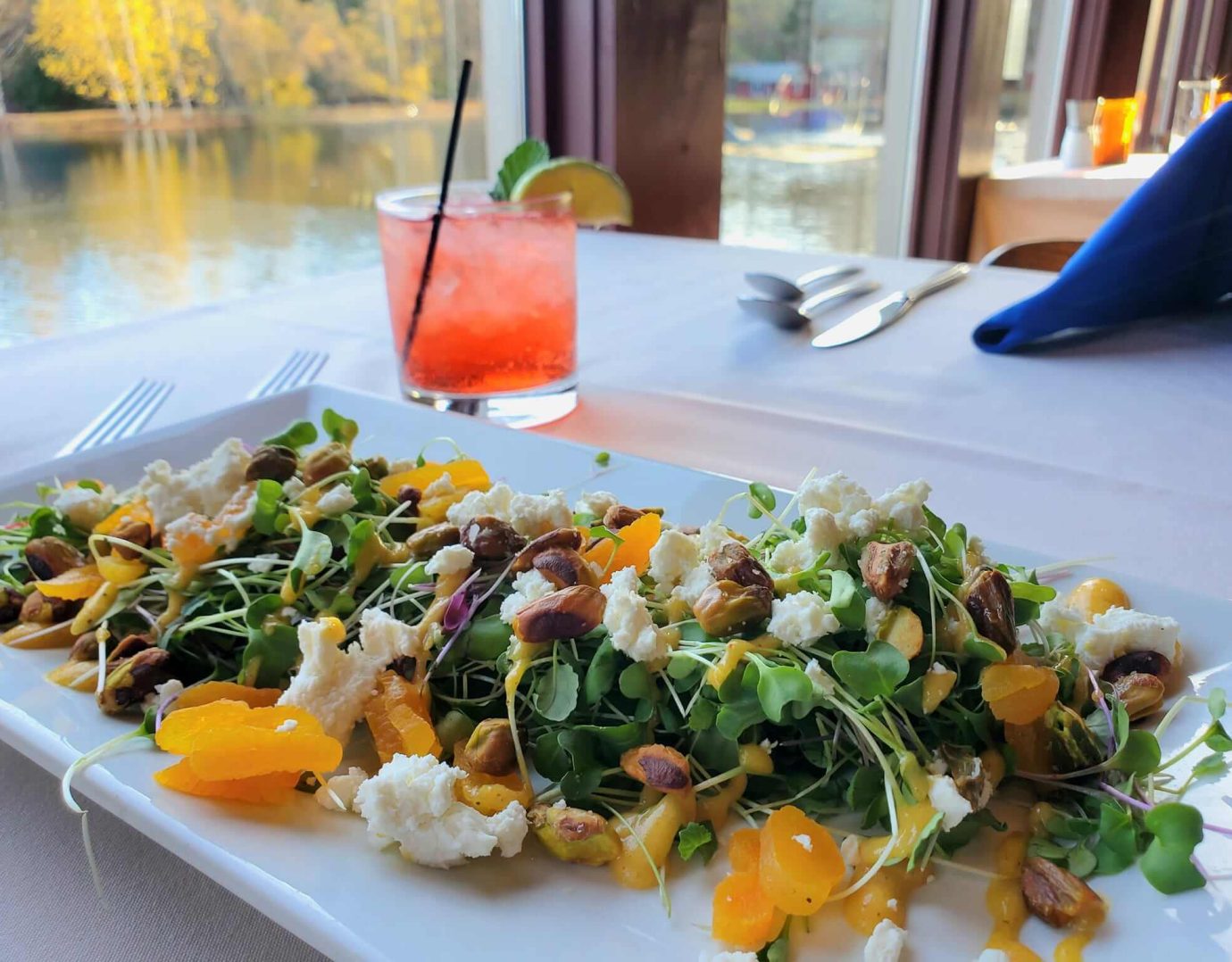 Fresh spring salad and cocktail at waterfront restaurant in the Poconos