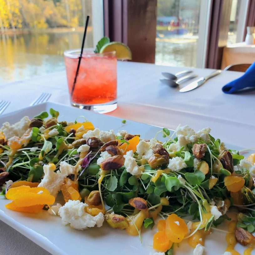 Fresh spring salad and cocktail at waterfront restaurant in the Poconos