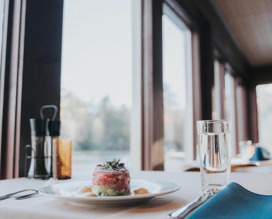 Tuna appetizer on table with view of lakeside Poconos Restaurant