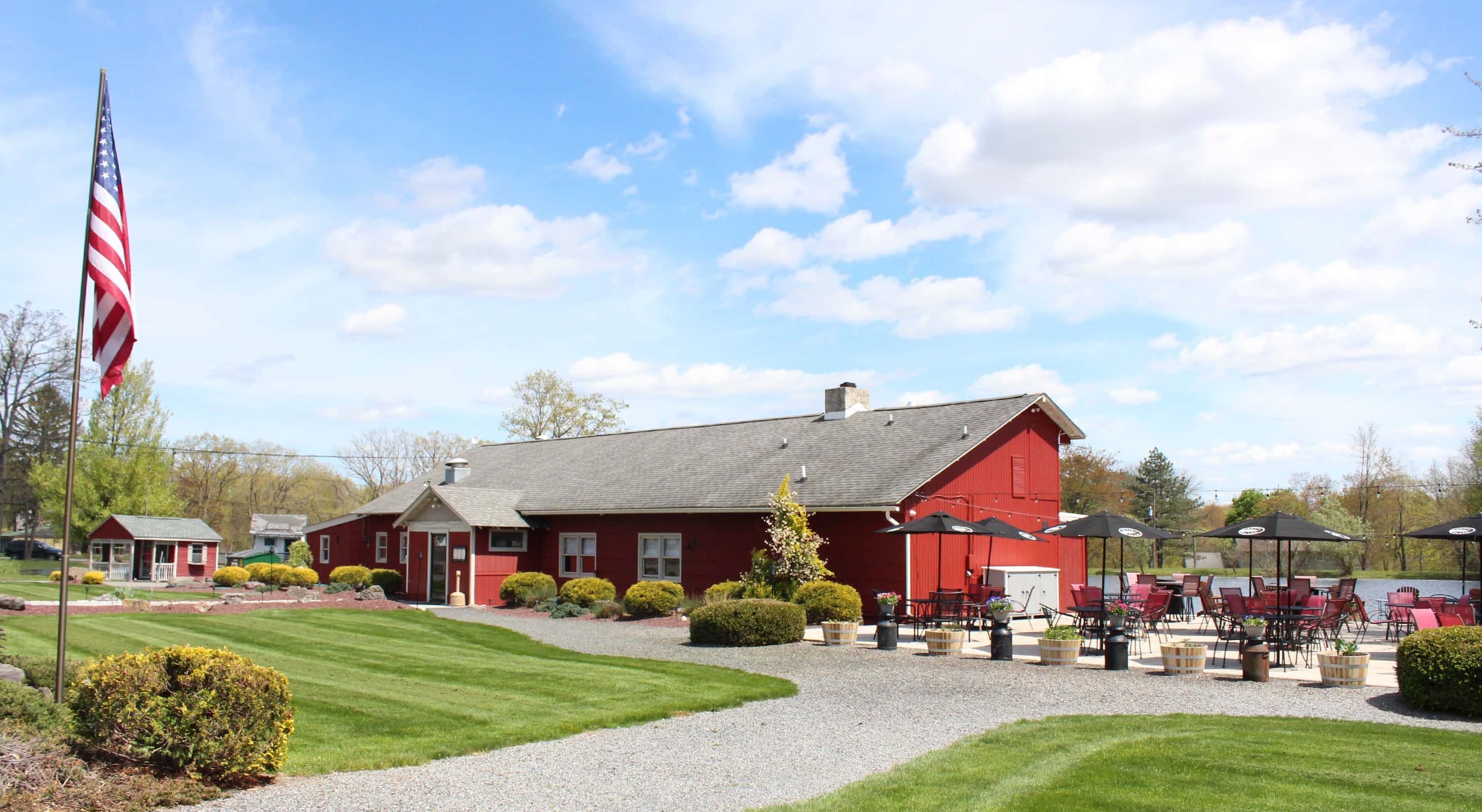 Red lakeside restaurant with patio seating