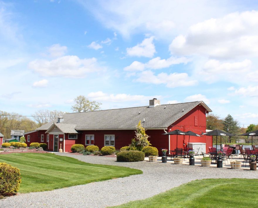 Red lakeside restaurant with patio seating