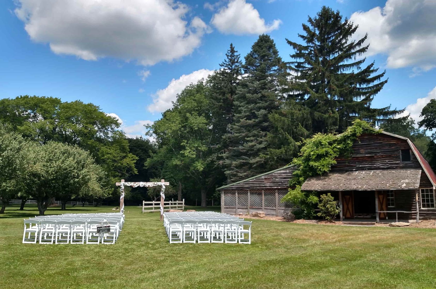 Rustic barn for weddings in the Poconos with chairs and arbor
