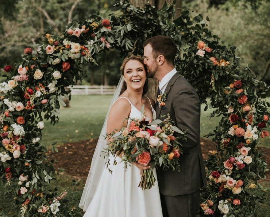 Couple standing in front of circle of flowers at PA wedding venue