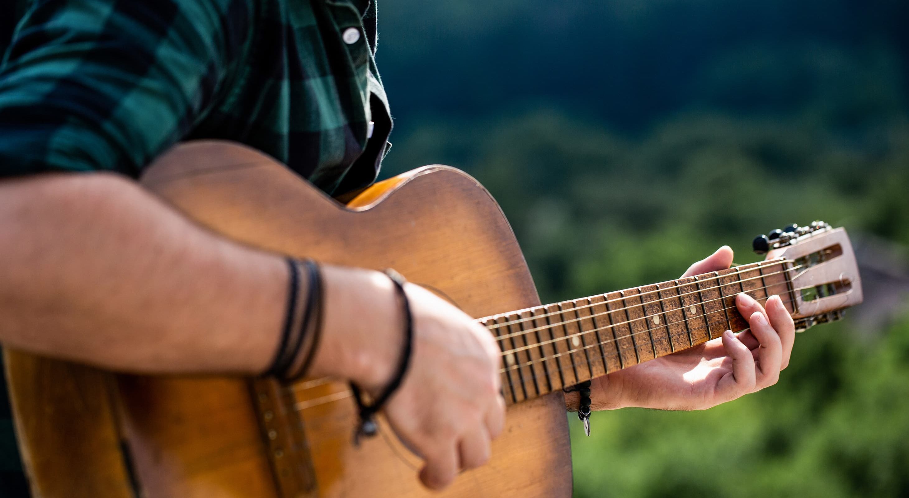 Man playing guitar at Poconos event with live music