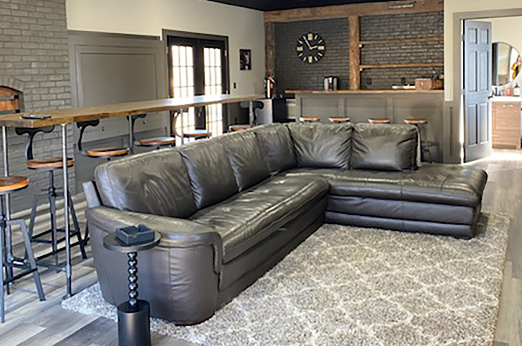 Modern living space with bar and leather sectional in Buck's Lounge