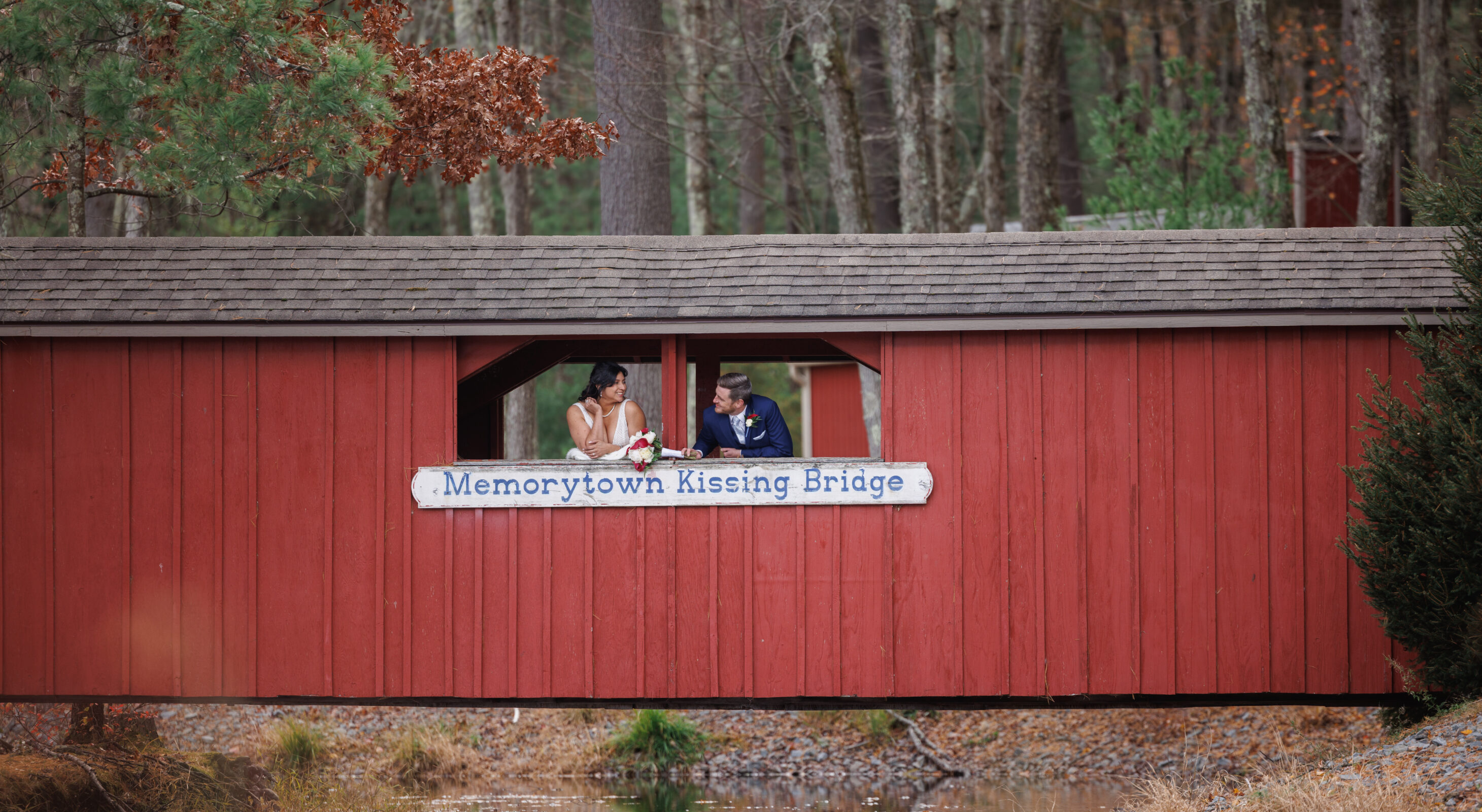 Couple kissing by cabins at lakefront wedding venue in Mount Pocono, PA