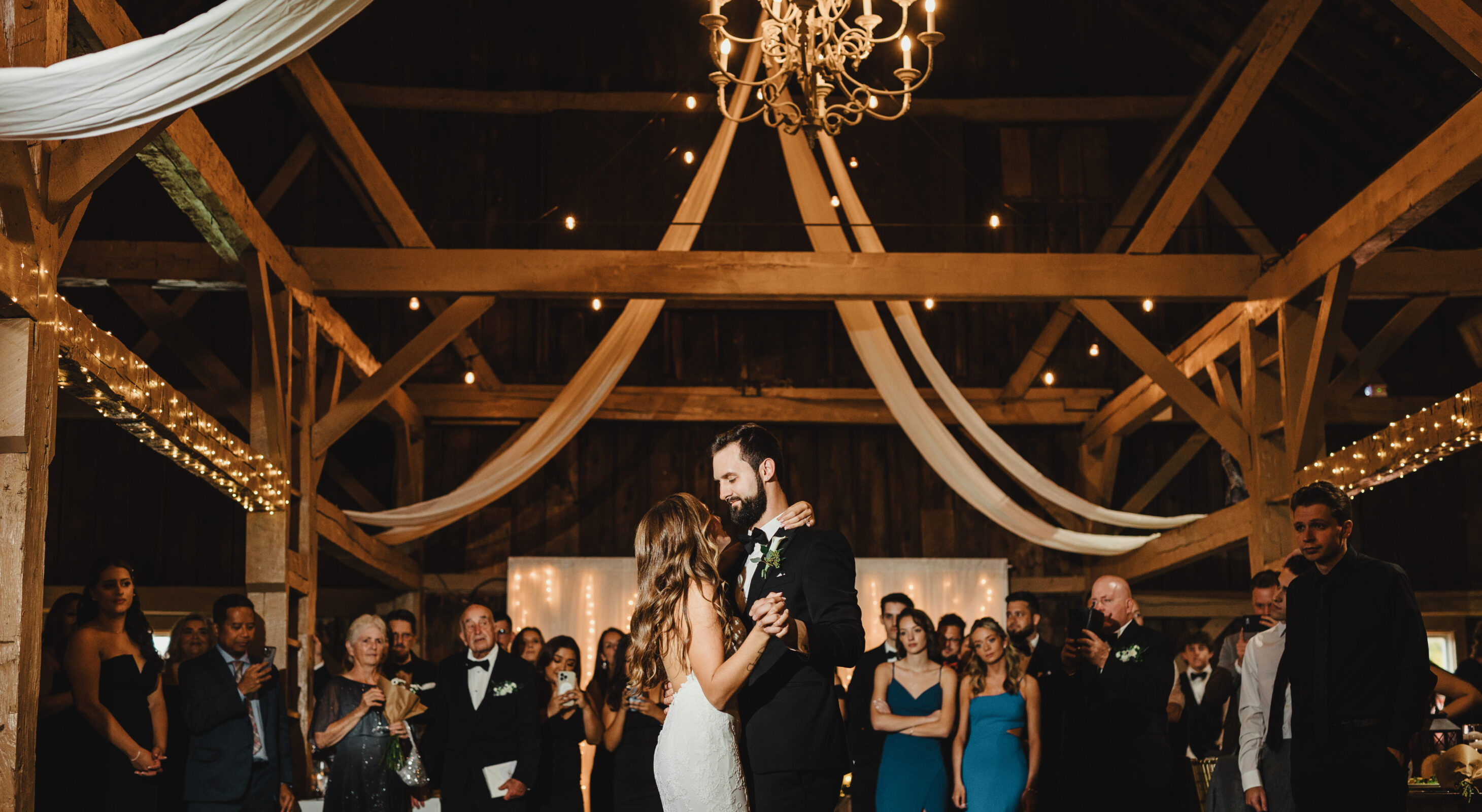 Couple kissing by cabins at lakefront wedding venue in Mount Pocono, PA