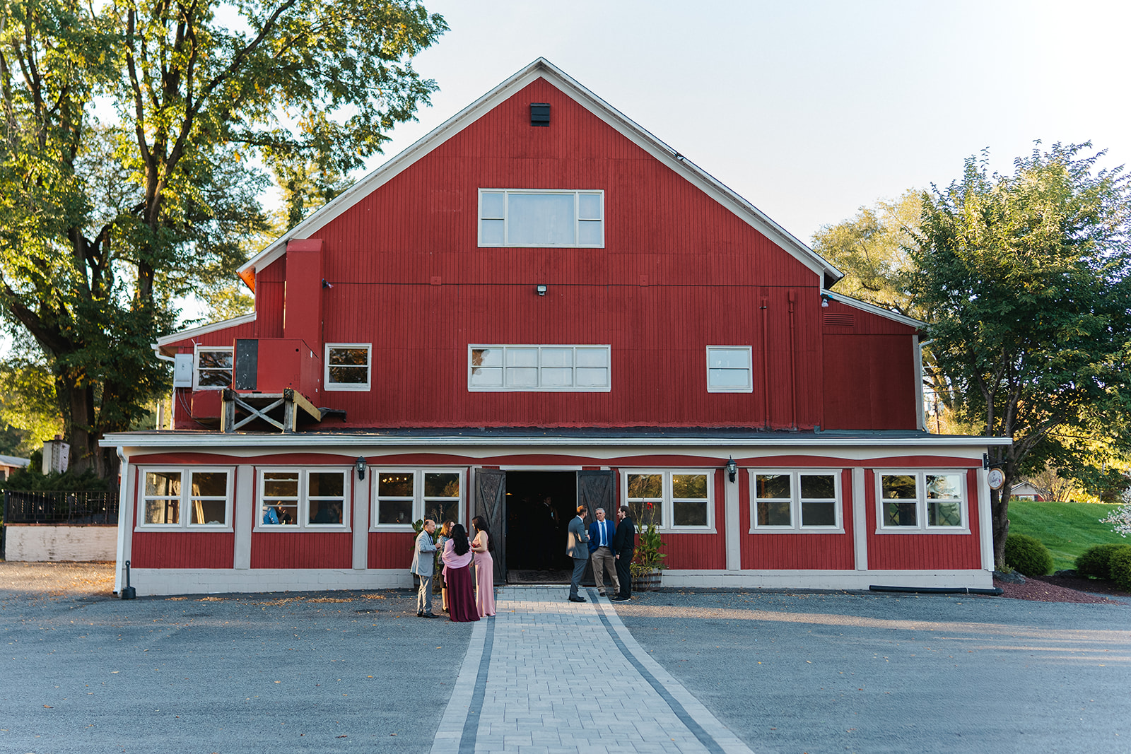 Couple walking through trees at Poconos mountain wedding venue